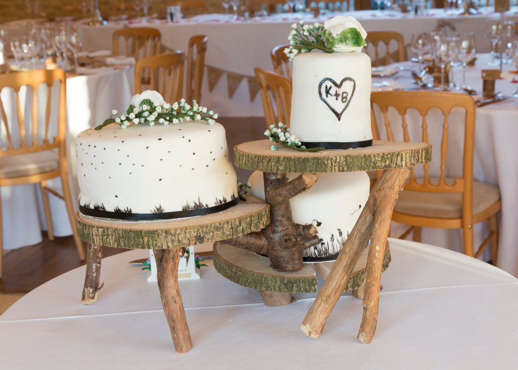 Tiered wooden cake stand, handcrafted for rustic weddings, available for rental or purchase in Bristol, UK. Photo Wedding Location The Kingscote Barn Tetbury